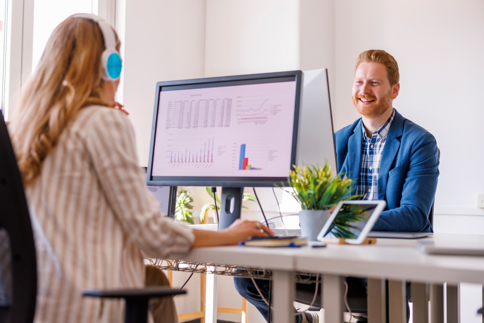 Business people working in modern office, sitting at desks and using computers; business colleagues doing finance reports while working in accountancy agency