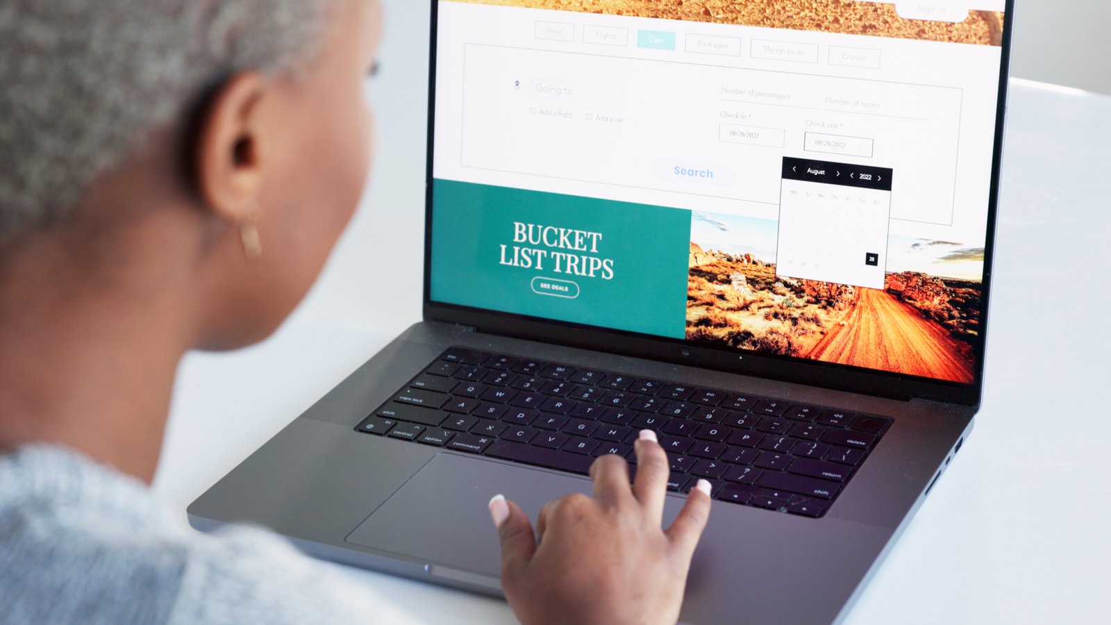 Laptop, hand and bucket list with a woman on the search online for an idea for a trip, holiday or v.